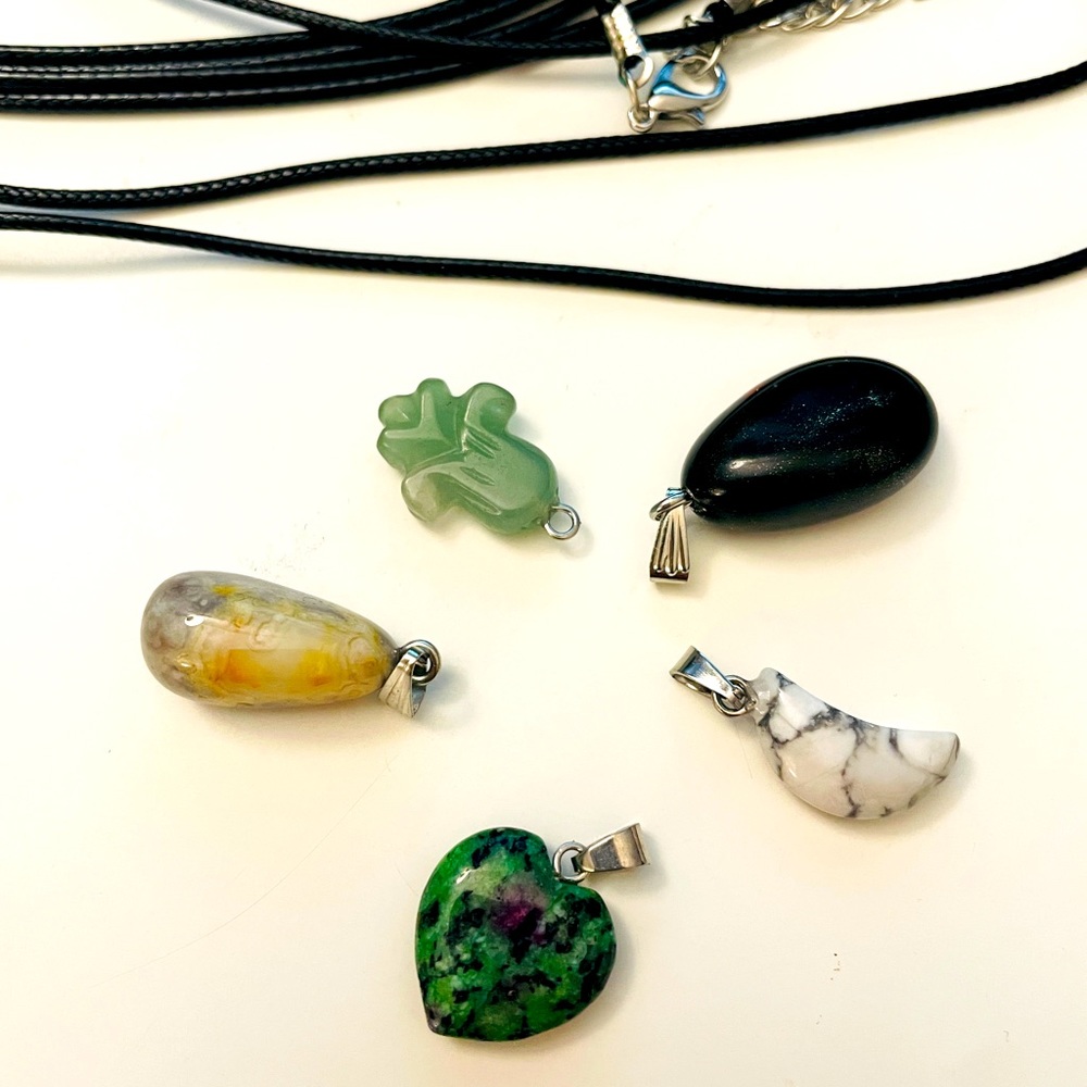 5 crystal pendents with black necklaces for each pendants